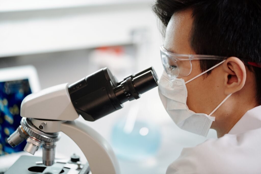 Scientist using a microscope in a Vitaquest laboratory, concept of research and development.
